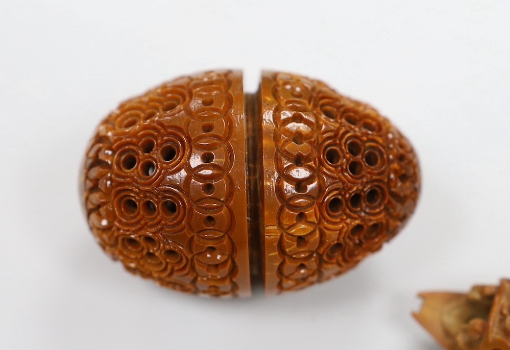 Five Chinese peach stone carvings, largest 4.2cm and a coquilla nut egg shaped box